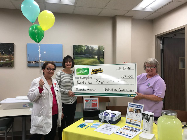 Evangeline, a winning member, with Member Service Representative Jane and Branch Manager Linda.